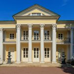 Двухэтажный жёлтый Летний домик графа Орлова с белыми колоннами среди деревьев Нескучного сада